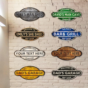 May include: Eight vintage-style metal signs with rounded edges and distressed paint. The signs feature various text, including "Welcome to Mike's Man Shed", "Welcome to David's Man Cave", "Welcome to Emily's She Shed", "David's Bar & Grill", "Personalized Your Text Here", "Custom Text Your Text Here", "Welcome to Dad's Garage", and "Welcome to Dad's Garage".