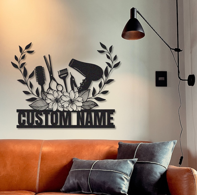 May include: Black metal wall art featuring a hair dryer, scissors, combs, and flowers with the text "CUSTOM NAME".