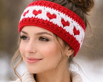 May include: A red and white crochet headband with a heart design. The headband is made from soft yarn and is worn around the forehead. This winter fashion accessory is a cosy item.