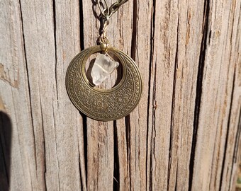 24&quot; Charm Necklace Antique Gold floral casing encompassing a stunning Clear Quartz stone. Clear quartz is a crystal that symbolizes clarity