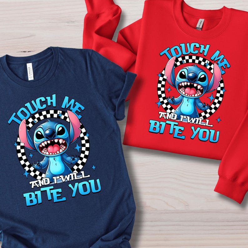 May include: Navy blue t-shirt and red sweatshirt featuring a cartoon character with the text "TOUCH ME AND I WILL BITE YOU". The character is surrounded by a black and white checkered circle.