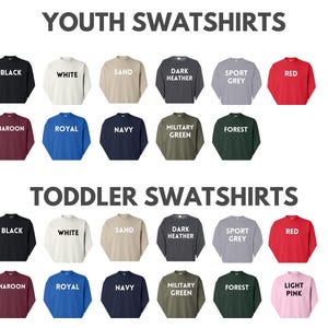 a collection of youth sweatshirts in various colors and styles, including black, white, sand, dark grey, sport grey, red, maroon, royal, navy, forest green, and light pink.