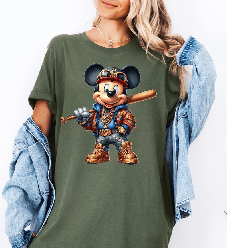 May include: A green t-shirt with a cartoon image of Mickey Mouse wearing a gold chain, a baseball cap, and holding a baseball bat.