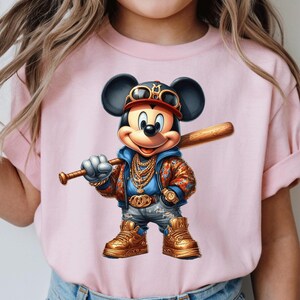 May include: A pink t-shirt with a cartoon image of Mickey Mouse wearing a gold chain, a baseball cap, and sunglasses. Mickey Mouse is holding a baseball bat and is wearing a blue jacket with a floral pattern.