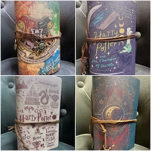 May include: Four different Harry Potter themed journals with various designs. The journals are all brown with a leather-like texture. The first journal has the Hogwarts crest and the words "Draco Dormiens Nunquam Titillandus" and "Ravenclaw". The second journal has a dark purple background with a crescent moon, stars, and the words "Harry Potter and the Chamber of Secrets". The third journal has a white background with the words "Harry Potter" and various Harry Potter themed images. The fourth journal has a dark blue background with a crescent moon, stars, and a triangle design.
