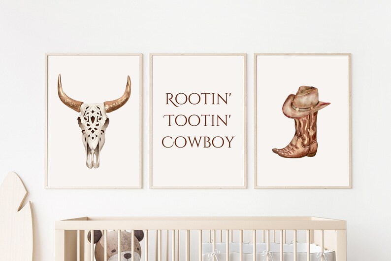 May include: Three framed watercolor prints with a Western theme. The prints feature a bull skull, the text "ROOTIN' TOOTIN' COWBOY", and a cowboy boot with a hat. The color palette includes shades of brown, beige, and white.