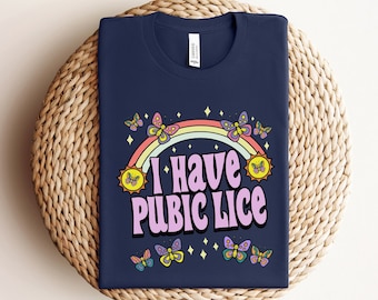 May include: A navy blue t-shirt with a rainbow, butterflies, and the text "I Have Pubic Lice" in pink letters.