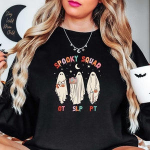 May include: Black sweatshirt with a graphic of three ghosts holding candy bags and the text "Spooky Squad OT SLP PT".