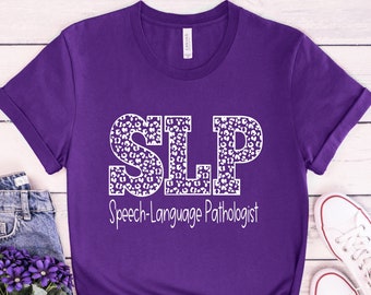 May include: Purple t-shirt with a white leopard print design that says "SLP Speech-Language Pathologist" on the front.