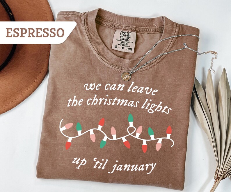 May include: A set of three ceramic mugs with a speckled, matte finish. The mugs are in shades of cream, light gray, and dark gray. Each mug has a simple, minimalist design and a rounded handle.