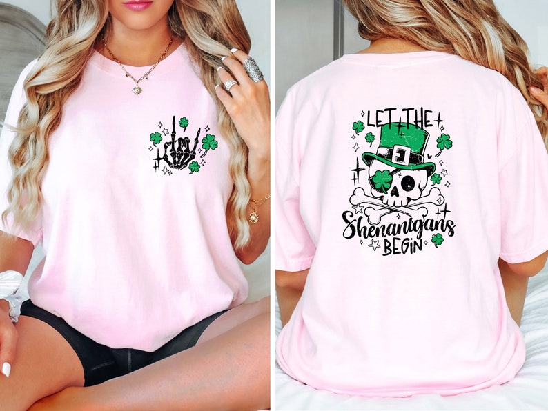 May include: Pink t-shirt with a skeleton hand giving the middle finger with shamrocks and stars on the front and a skull wearing a green leprechaun hat with the text "Let the Shenanigans Begin" on the back.