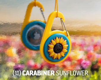 May include: Yellow carabiner with a blue sunflower design. The text (AIR TAG) CARABINER SUNFLOWER is visible below the carabiner.