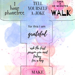May include: A printable self-care activity card with a watercolor background. The card has a cut-out design and includes phrases like "Tell yourself a joke", "Take a 20 minute walk", and "Make someone a gift".