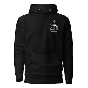 May include: Black hoodie with a front pocket and a hood. The hoodie features a white graphic on the upper left chest, including a cross, a book, and the text "Ties are not forgotten, they're secured."