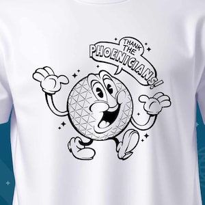 May include: White t-shirt with a black and white illustration of a cartoon character with a speech bubble that says "Thank the Phoenicians!"