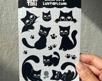 May include: A sheet of black cat stickers with various poses, including a cat peeking over a wall, a cat sitting, a cat curled up, and a cat playing with yarn. The stickers are on a white background with a grid pattern. The text "LUVTARI black cats LUVTARI.com" is at the top of the sheet.