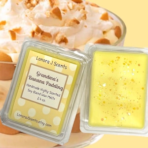 May include: Two yellow wax melt squares in clear plastic containers. One has a label that reads "Grandma's Banana Pudding" and "Lonora J Scents". The other has glitter. The wax melts are 2.4 oz.