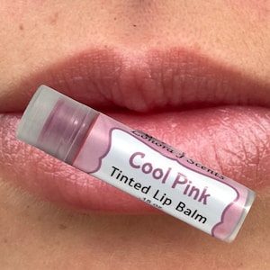 May include: A pink tinted lip balm tube with the text "Cool Pink Tinted Lip Balm" and "Lolhora Scents" on the label.