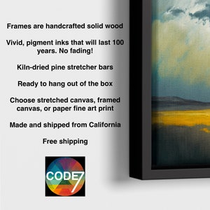 May include: A framed landscape art print featuring a dark, cloudy sky above a golden yellow field and dark water. The text reads: Frames are handcrafted solid wood, Vivid, pigment inks that will last 100 years. No fading!, Kiln-dried pine stretcher bars.