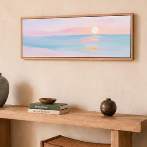Soft pastel ocean wall art with a simple sunset horizon, formatted as a black framed canvas print for serene bedrooms, living rooms, and coastal interiors.