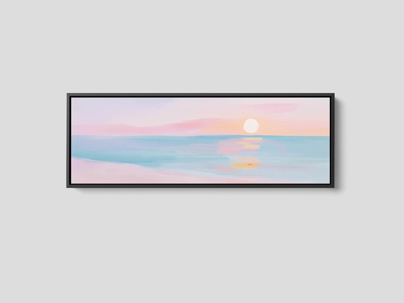 Scandinavian-inspired seascape with a pastel pink sky and blue water, displayed as a panoramic framed canvas print above a bed, sofa, or console.