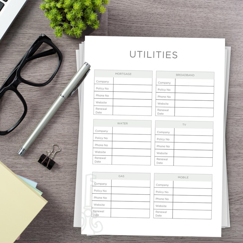 Printed Page on a desk. Example of one of the pages in the Rental Property Planner Bundle - Utilities Info Sheet