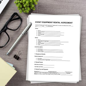 May include: A blank Event Equipment Rental Agreement form with sections for Owner and Renter information, Event Description, Equipment Details, Rental Period, and Rental Fee and Payment. The form is printed on white paper and is lying on a wooden surface.