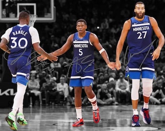 May include: Three basketball players wearing blue and white jerseys with the word "Minnesota" and a number on the front. The players are on a basketball court.