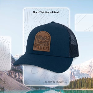 May include: A navy blue trucker hat with a brown leather patch featuring a mountain scene and the text "Banff National Park".