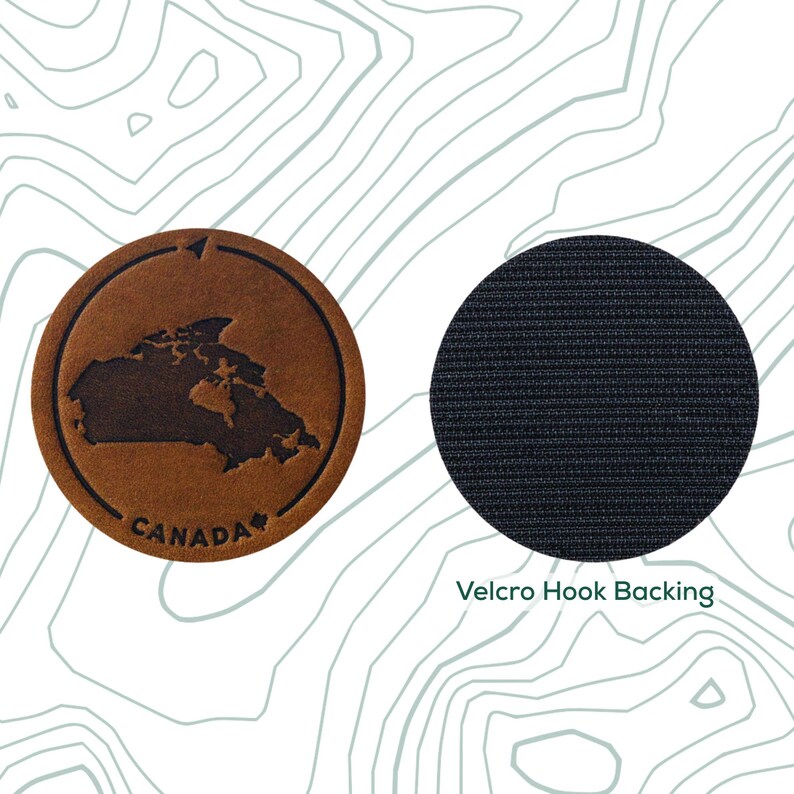 May include: A brown leather patch featuring an outline of Canada and the text "CANADA" in white. The patch has a black hook and loop backing.