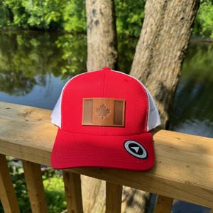 RED Canada Leather Patch Trucker Hat