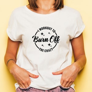May include: White t-shirt with a black circle graphic that says "I workout to burn off the crazy".