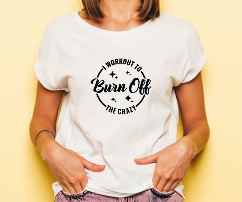 May include: White t-shirt with a black circle graphic that says "I workout to burn off the crazy".
