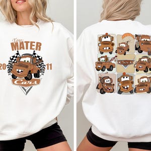 A white sweatshirt with a graphic design featuring cartoon cars from the movie Cars.
