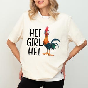 a woman wearing a t - shirt with a rooster on it