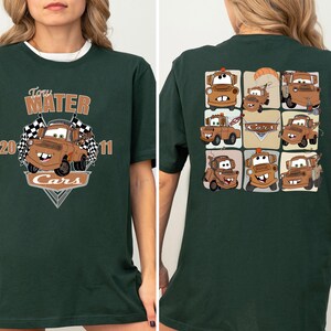 A green t-shirt with a graphic design featuring multiple cartoon cars, including the character Tom Mater.