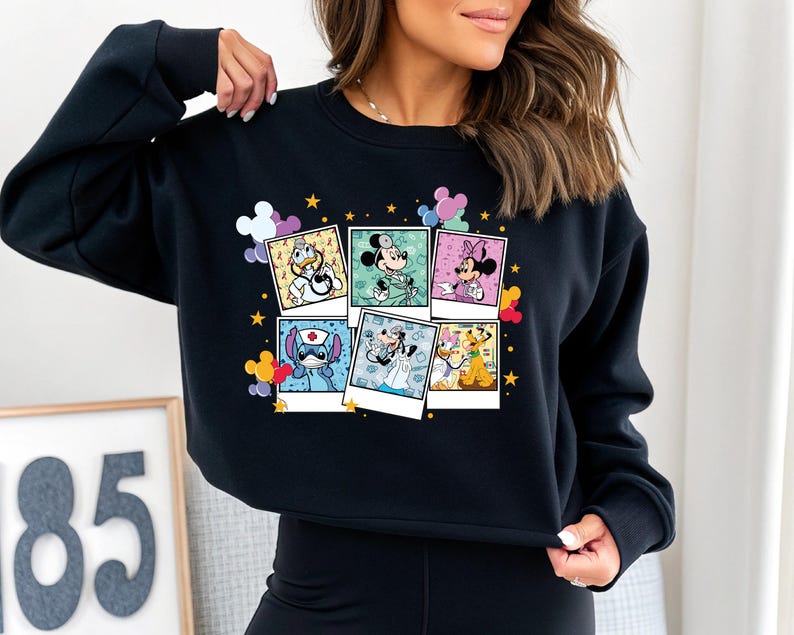 a woman wearing a mickey mouse sweatshirt and leggings