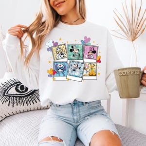 a woman sitting on a bed holding a cup of coffee