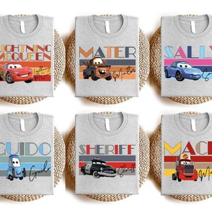 a set of four t - shirts with cars on them