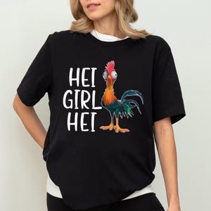 a woman wearing a black shirt with a rooster on it