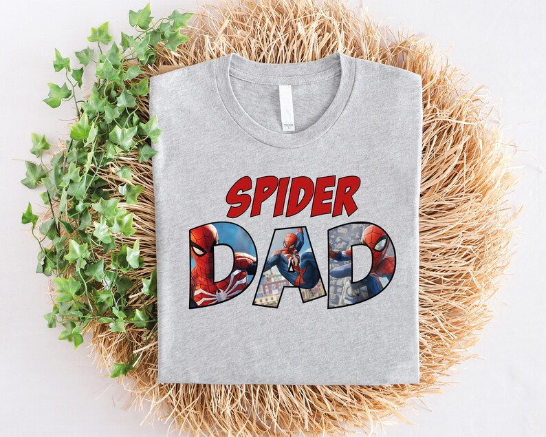 May include: Gray t-shirt with the text "Spider Dad" in red and a graphic of Spider-Man in red and blue.