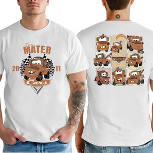 A white t-shirt with a graphic design featuring cartoon cars from the Cars movie franchise.