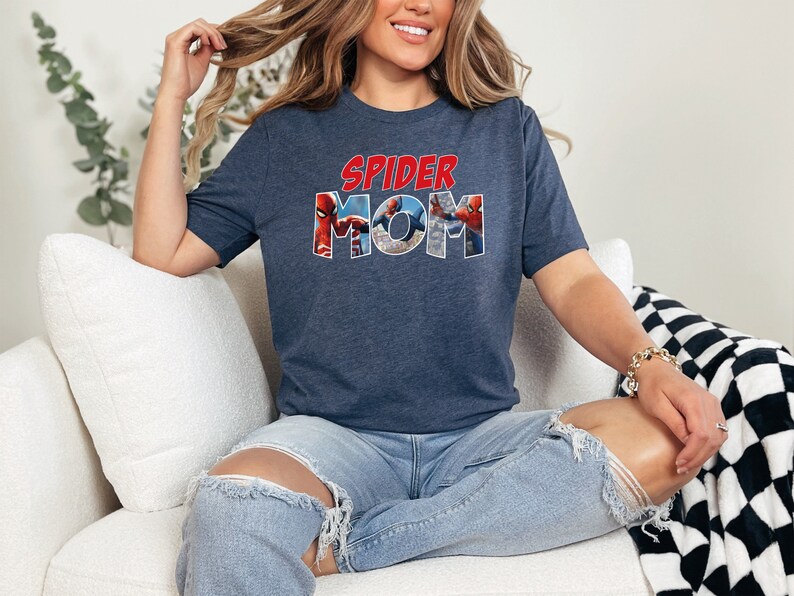 May include: A navy blue t-shirt with a graphic of Spider-Man characters forming the words "SPIDER MOM".