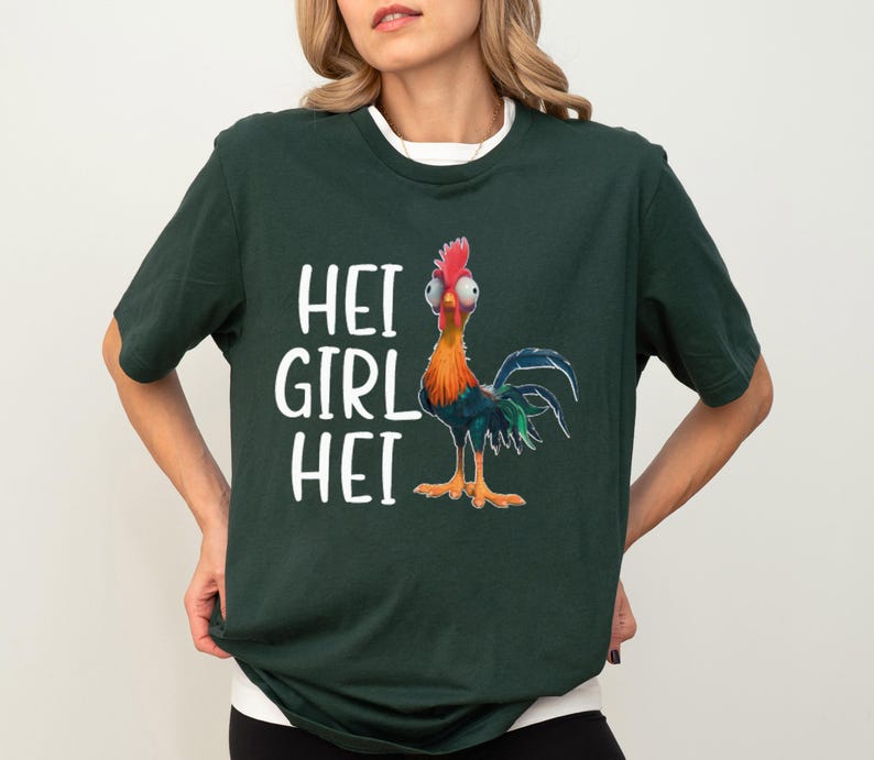 a woman wearing a green shirt with a rooster on it