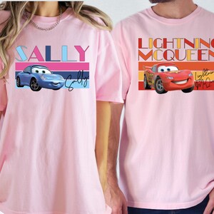 a man and a woman wearing matching pink shirts