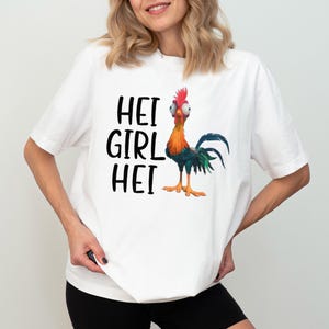 a woman wearing a white shirt with a rooster on it