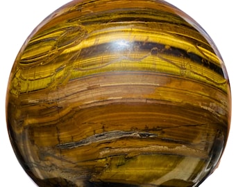 Puede incluir: Una gran esfera de ojo de tigre pulida con bandas doradas, marrones y negras. La esfera es lisa y reflectante, con un ligero brillo.