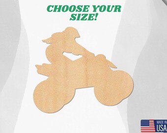 May include: A wooden cutout of a person riding an ATV. The cutout is unpainted and ready to be decorated.