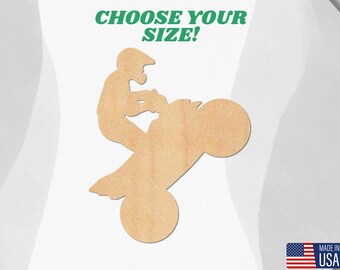 May include: A wooden cutout of a person riding a dirt bike. The cutout is unpainted and ready to be decorated.