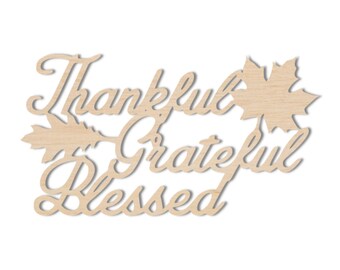 May include: Wooden sign with the words "Thankful Grateful Blessed" in a cursive font. The sign is decorated with two stylized leaf designs.